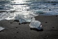 large pieces of iceburg on black sand beach in Iceland