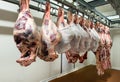 Large pieces of meat hanging in cooler