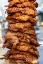 Large pieces of meat on a spit at street food market in Thailand. Crilled skewered chiken meat on spit. Fast food