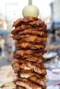 Large pieces of meat on a spit at street food market in Thailand. Crilled skewered chiken meat on spit. Fast food