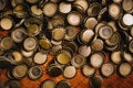 Large pile of beer bottle caps on wooden desk