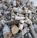 A large pile of birch firewood. The tree is chopped into pieces, the furnace of the house or bathhouse with birch firewood. Birch Royalty Free Stock Photo