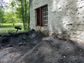 Large pile of black coat and soot next to white building and lake