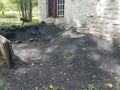 Large pile of black coat and soot next to white building and lake