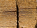 A large pile of boards sawn from trees on a sawmill for the procurement of building materials for construction. Construction indus Royalty Free Stock Photo