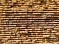 A large pile of boards sawn from trees on a sawmill for the procurement of building materials for construction. Construction