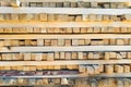 A large pile of boards sawn from trees on a sawmill for the procurement of building materials for construction. Construction Royalty Free Stock Photo