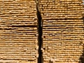 A large pile of boards sawn from trees on a sawmill for the procurement of building materials for construction. Construction Royalty Free Stock Photo