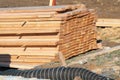 A large pile of boards sawn from trees on a sawmill for the procurement of building materials for construction Royalty Free Stock Photo