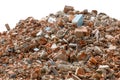 A large pile of broken red bricks, fragments of tiles and concrete, isolated on a white background. Remains of a Royalty Free Stock Photo