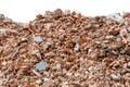 A large pile of broken red bricks, fragments of tiles and concrete, isolated on a white background. Remains of a Royalty Free Stock Photo