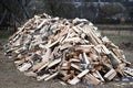 Large pile of chopped birch firewood on ground in the village. Fuel for stove heating. Wooden firewood stacked. Pile of chopped Royalty Free Stock Photo