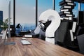 Large pile of document folders and stack of ring binders flooding office workplace with pc and skyline view; question mark;