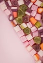 A large pile of mixed sweets on wooden background Royalty Free Stock Photo