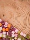 A large pile of mixed sweets on wooden background