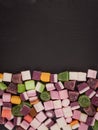 A large pile of mixed sweets on wooden background Royalty Free Stock Photo
