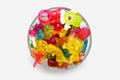 A large pile of multi-colored jelly marmalade candies in a glass bowl on a white isolated background Royalty Free Stock Photo