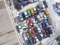 A large pile of old cars prepared for recycling in the winter season, photo taken from a flying machine