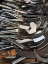 A large pile of old school scytes that are used to cut weeds Royalty Free Stock Photo