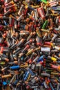 Large pile of old, used, corroded batteries at a recycling centre