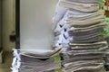 A large pile of paper stacks of old papers