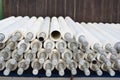 a large pile of pipes in an unfinished warehouse room being transported