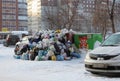 A large pile of plastic bags of garbage and household waste in the city dump in the winter in Novosibirsk pollutes the environment