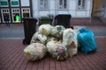 Large Plastic Garbage Bags Outside of Bins on Sidewalk