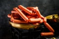 large pile of raw long thin wieners on antiquarian scales Royalty Free Stock Photo