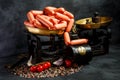 Large pile of raw long thin wieners on antiquarian scales Royalty Free Stock Photo