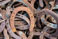 Large pile of rusty used Horseshoes