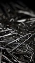 a large pile of triangular shaped shiny silver paper clips