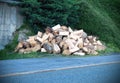 A large pile of wood that has been cut and split into firewood to be used as fuel for heating in fireplaces and furnaces in the Royalty Free Stock Photo