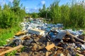 Large piles of garbage in green forest were not properly disposed. Destroying nature.