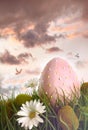 Large pink egg with flowers in tall grass