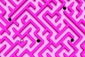 Large pink maze or labyrinth with chrome ball and holes over pink background, success, strategy or solution concept