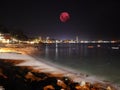 Large pink moon over the Patong beach skies of Phuket Thailand Royalty Free Stock Photo