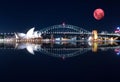 Large Pink moon rising behind Sydney CBD buildings NSW Australia Royalty Free Stock Photo