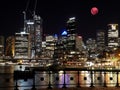 Large Pink moon rising behind Sydney CBD buildings NSW Australia Royalty Free Stock Photo