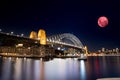 Large Pink moon rising behind Sydney CBD buildings NSW Australia Royalty Free Stock Photo