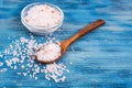 Large pink sea salt on blue background Royalty Free Stock Photo