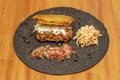 Large plantain patacon stuffed with cheese and shredded meat with cole slaw and pico de gallo