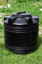 A large plastic black barrel for a summer shower. A container for storing water, food and fuel Royalty Free Stock Photo