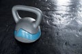 A large plastic kettlebell on rubber floor matting at the gym. Empty space on the right Royalty Free Stock Photo