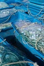 Large plastic tubs filled with industrial size fishing and trawling nets used in the offshore fishing industry Royalty Free Stock Photo