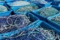 Large plastic tubs filled with industrial size fishing and trawling nets used in the offshore fishing industry Royalty Free Stock Photo