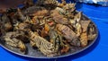 Large plate with a grilled seafood lobsters. BBQ exotic food on the beach. Selective focus Royalty Free Stock Photo