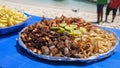 Large plate with a mix of grilled seafood shrimp, octopus, tuna fish, squid. BBQ exotic food on the beach Royalty Free Stock Photo