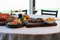 large platter of seafood, steak, fries, sides, and wines Royalty Free Stock Photo