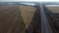 Large plowed field plowed land, yellow dry straw after harvesting wheat, lake